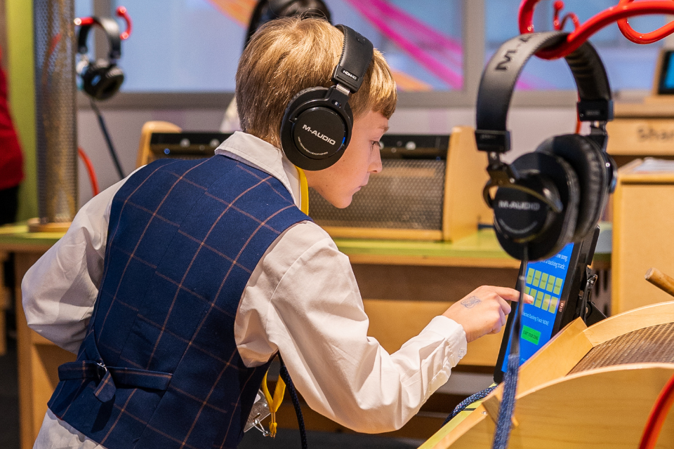 si1 Child exploring music studio